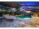 Enclosed in-ground pool and patio area offers a pizza oven and ample entertaining space at 11804 Carrollwood Village Cv, Tampa, FL 33618