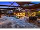 This screened-in pool area is an outdoor oasis with a kitchen, seating, and pizza oven at 11804 Carrollwood Village Cv, Tampa, FL 33618