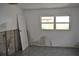 Bedroom needing renovation, showing damaged walls, block foundation and floor at 119 18Th Nw St, Ruskin, FL 33570