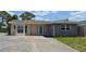 Charming single-story home featuring stucco and stone accents and a wide driveway at 119 18Th Nw St, Ruskin, FL 33570