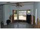 Living Room needing repair with tile flooring, large windows, and damage to the walls at 119 18Th Nw St, Ruskin, FL 33570