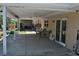 Covered patio area with outdoor seating and furniture with access to yard and home at 119 18Th Nw St, Ruskin, FL 33570