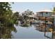 Waterfront view of houses with docks and boats under a clear sky on a sunny day at 119 18Th Nw St, Ruskin, FL 33570