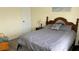 Bedroom with a wooden headboard, soft lighting, and neutral bedding at 12328 Shafton Rd, Spring Hill, FL 34608
