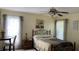 Comfortable bedroom featuring soft natural light, a ceiling fan, and decorative accents at 12328 Shafton Rd, Spring Hill, FL 34608