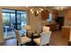 Bright dining area with glass table and modern chairs, next to an exterior lanai at 12328 Shafton Rd, Spring Hill, FL 34608