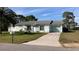 Charming single-story home with a well-maintained lawn and a long concrete driveway at 12328 Shafton Rd, Spring Hill, FL 34608