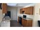 Traditional kitchen with light wood cabinets, gray countertops, stainless steel appliances, and a black range at 12328 Shafton Rd, Spring Hill, FL 34608