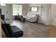 Cozy living room with light colored walls, luxury vinyl flooring, and lots of natural light at 12328 Shafton Rd, Spring Hill, FL 34608