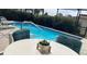 Backyard pool featuring lounge chairs, a table, and a calming setting at 12328 Shafton Rd, Spring Hill, FL 34608