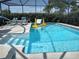 Pool and spa combination with a safety handrail at 12328 Shafton Rd, Spring Hill, FL 34608