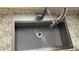 Close up of a stainless steel kitchen sink with a pull-down faucet and a built-in drain board at 12328 Shafton Rd, Spring Hill, FL 34608