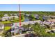 An aerial shot of a two-story townhome featuring manicured landscaping, mature trees, and convenient parking at 12443 Country White Cir, Tampa, FL 33635