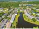 An aerial view of a tranquil townhome community with a pond, mature trees, and convenient parking at 12443 Country White Cir, Tampa, FL 33635