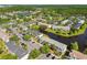 Overhead view of a serene townhome community featuring a pond, mature trees, and convenient parking at 12443 Country White Cir, Tampa, FL 33635