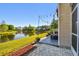 Backyard with scenic pond views, complemented by patio space, offering an ideal spot for outdoor relaxation at 12443 Country White Cir, Tampa, FL 33635