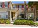 Inviting townhome with red shutters, lush landscaping, and a decorative front door at 12443 Country White Cir, Tampa, FL 33635