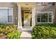 Charming front entrance with a decorative wreath and well-manicured landscaping at 12443 Country White Cir, Tampa, FL 33635