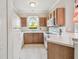 Traditional kitchen with light wood cabinets, white appliances, and a cozy window view at 12443 Country White Cir, Tampa, FL 33635