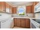 Traditional kitchen featuring white appliances, wood cabinets, and bright countertops at 12443 Country White Cir, Tampa, FL 33635