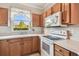 Traditional kitchen with wood cabinets and white appliances, offering a functional layout at 12443 Country White Cir, Tampa, FL 33635