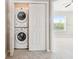 Convenient laundry closet with stacked washer and dryer offers space-saving functionality, situated off the main room at 12443 Country White Cir, Tampa, FL 33635