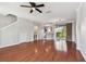 Open living space with hardwood floors leading to the kitchen and a scenic backyard view at 12443 Country White Cir, Tampa, FL 33635