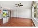 Open-concept living area boasting hardwood floors and a sliding glass door to the backyard at 12443 Country White Cir, Tampa, FL 33635