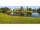 Expansive pond view, creating a serene backdrop for these well-maintained residential homes and green lawns at 12443 Country White Cir, Tampa, FL 33635