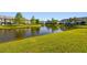 Scenic pond view with lush green grass on each side, providing a tranquil and picturesque landscape at 12443 Country White Cir, Tampa, FL 33635