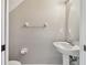 Small, well-lit powder room with a pedestal sink and neutral color palette at 12443 Country White Cir, Tampa, FL 33635