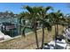 Backyard with palm trees with views of the water and boat docks at 12478 Capri Circle N # 2, Treasure Island, FL 33706