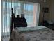 Bedroom with a view of the water through the large window with vertical blinds at 12478 Capri Circle N # 2, Treasure Island, FL 33706