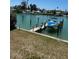 The property features a personal boat dock with a lift, perfect for boating enthusiasts at 12478 Capri Circle N # 2, Treasure Island, FL 33706