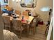 Bright dining room with stylish mirror, light fixture, and table with wood chairs at 12478 Capri Circle N # 2, Treasure Island, FL 33706