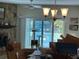Dining room with a stone fireplace and sliding glass doors leading to the water at 12478 Capri Circle N # 2, Treasure Island, FL 33706
