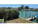 Scenic view of waterfront property featuring a private boat dock and lush greenery at 12478 Capri Circle N # 2, Treasure Island, FL 33706