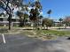 Exterior shot of townhouses with lush surrounding trees at 12478 Capri Circle N # 2, Treasure Island, FL 33706