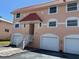 View of townhouses with garages and red roofs at 12478 Capri Circle N # 2, Treasure Island, FL 33706