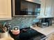 Bright kitchen featuring stainless steel appliances, white cabinets, and elegant countertops at 12478 Capri Circle N # 2, Treasure Island, FL 33706