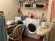 Organized laundry room with neatly arranged shelves filled with supplies and a modern washer and dryer at 12478 Capri Circle N # 2, Treasure Island, FL 33706