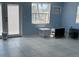 Living area with white tile floors, serene blue walls, and a view through the window at 12478 Capri Circle N # 2, Treasure Island, FL 33706