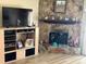 Living room with stone fireplace and a light wood media center at 12478 Capri Circle N # 2, Treasure Island, FL 33706