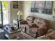 Living area with recliner seating and sliding glass doors leading to a balcony at 12478 Capri Circle N # 2, Treasure Island, FL 33706