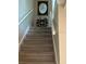 Carpeted staircase with white railing leads to the upper level, and features decor accents at 12478 Capri Circle N # 2, Treasure Island, FL 33706