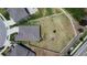 Overhead view of a home's backyard, bordered by a white fence, and in close proximity to other neighborhood homes at 13506 Wild Ginger St, Riverview, FL 33579