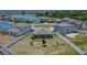 Aerial view of backyard featuring a fire pit area, surrounded by a white fence for privacy at 13506 Wild Ginger St, Riverview, FL 33579