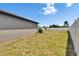 Large backyard with green grass and a white fence at 13506 Wild Ginger St, Riverview, FL 33579
