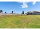 Fenced backyard featuring trees and lush grass, ideal for outdoor enjoyment at 13506 Wild Ginger St, Riverview, FL 33579