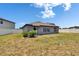 Side view of the home showcasing the backyard and slider leading inside from living space at 13506 Wild Ginger St, Riverview, FL 33579